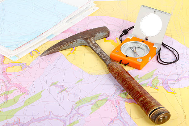 Geological compassand hammer on a a geological map